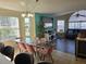 Open-concept dining and living area featuring stylish furniture, large windows, and a comfortable seating area at 8704 Knightsbridge Ct # B, Kissimmee, FL 34747