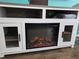 Close up of entertainment center featuring an electric fireplace, drawers, and rustic wood top at 8704 Knightsbridge Ct # B, Kissimmee, FL 34747