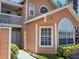 Charming two-story home featuring unique architectural windows, a balcony, and well-maintained landscaping at 8704 Knightsbridge Ct # B, Kissimmee, FL 34747