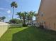 Side view of a two story condominium building with green lawn and palms at 8704 Knightsbridge Ct # B, Kissimmee, FL 34747