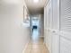 Bright hallway featuring white louvered closet doors and neutral-toned tile flooring at 8704 Knightsbridge Ct # B, Kissimmee, FL 34747