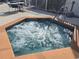 Inviting hot tub with tile surround and seating area for relaxation at 8704 Knightsbridge Ct # B, Kissimmee, FL 34747