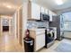 Well-lit kitchen featuring stainless steel appliances, modern cabinets, and gray tile backsplash at 8704 Knightsbridge Ct # B, Kissimmee, FL 34747