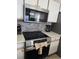 Close-up of stainless steel stove and microwave, with modern appliances and sleek design elements at 8704 Knightsbridge Ct # B, Kissimmee, FL 34747