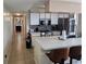 Well-lit kitchen featuring tile floors, white cabinets, modern appliances, and breakfast bar seating at 8704 Knightsbridge Ct # B, Kissimmee, FL 34747