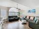 Comfortable living room with a large window, modern furniture, and stylish hardwood floors creates an inviting space at 8704 Knightsbridge Ct # B, Kissimmee, FL 34747