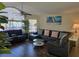 Well-lit living room with large windows, hardwood floors, and stylish, comfortable furniture at 8704 Knightsbridge Ct # B, Kissimmee, FL 34747
