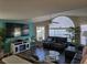 Spacious living room features large windows, high ceilings, a modern entertainment center and comfortable leather seating at 8704 Knightsbridge Ct # B, Kissimmee, FL 34747