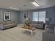 Cozy lounge area featuring neutral-toned sofas, artwork, and ample natural light at 8704 Knightsbridge Ct # B, Kissimmee, FL 34747