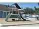 Fun playground with slide, tire swing, and climbing wall next to pool at 8704 Knightsbridge Ct # B, Kissimmee, FL 34747
