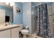 Cozy bathroom features a shower and vanity with blue paint at 8719 Rockingham Ter # B, Kissimmee, FL 34747