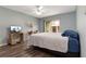 Comfortable bedroom with ceiling fan and access to a balcony at 8719 Rockingham Ter # B, Kissimmee, FL 34747