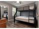 Bedroom with bunkbeds, ceiling fan, closet with mirror, and wood flooring at 8719 Rockingham Ter # B, Kissimmee, FL 34747