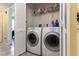 Laundry room with washer and dryer and overhead storage at 8719 Rockingham Ter # B, Kissimmee, FL 34747