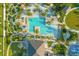 Aerial view of a community pool featuring mini golf, lounge chairs, and lush landscaping at 8811 Bally Neal Loop, Davenport, FL 33896