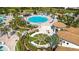 Aerial view of community pool surrounded by lounge chairs and a splash pad at 8811 Bally Neal Loop, Davenport, FL 33896