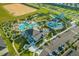 Extensive resort community aerial view with a pool, water slides, mini-golf, and a spacious parking lot at 8811 Bally Neal Loop, Davenport, FL 33896