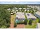 Aerial view of a backyard featuring a screened pool, green lawn, and privacy landscaping at 8811 Bally Neal Loop, Davenport, FL 33896