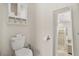 Bright bathroom featuring toilet, storage cabinet, toilet paper holder and walk-in shower at 8811 Bally Neal Loop, Davenport, FL 33896