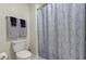 Bathroom featuring a toilet, toilet paper holder, and a shower with a decorative shower curtain at 8811 Bally Neal Loop, Davenport, FL 33896