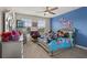 Charming bedroom featuring bright blue accent wall and playful decor at 8811 Bally Neal Loop, Davenport, FL 33896