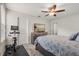 Bedroom featuring a ceiling fan, a TV on a dresser, workout equipment and a door at 8811 Bally Neal Loop, Davenport, FL 33896