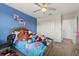 Bright bedroom with blue accent wall, closet, en-suite bath, and playful decor at 8811 Bally Neal Loop, Davenport, FL 33896