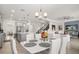 Open concept dining area with access to the kitchen and living room, chandelier, and comfortable seating at 8811 Bally Neal Loop, Davenport, FL 33896