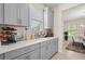 Kitchen area with gray cabinets, stylish decor, and plenty of counter space at 8811 Bally Neal Loop, Davenport, FL 33896