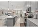 Modern kitchen with stainless steel appliances, tiled backsplash, and breakfast bar, ideal for cooking at 8811 Bally Neal Loop, Davenport, FL 33896