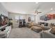 Spacious living room with plush gray sofas, arcade games, and a popcorn machine at 8811 Bally Neal Loop, Davenport, FL 33896