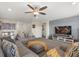 Cozy living room with comfortable seating, TV, and gray carpet, creating an inviting and relaxing atmosphere at 8811 Bally Neal Loop, Davenport, FL 33896