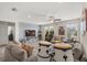 Spacious living room featuring a ceiling fan, arcade games, comfortable seating, and a mounted television at 8811 Bally Neal Loop, Davenport, FL 33896