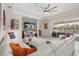 Bright living room with a large white sectional, stylish decor, and sliding glass doors to the outdoor space at 8811 Bally Neal Loop, Davenport, FL 33896