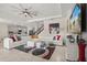 Spacious living room with a modern sectional, stylish rug, and an open layout leading to the kitchen and staircase at 8811 Bally Neal Loop, Davenport, FL 33896