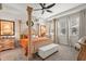 Elegant bedroom with a four-poster bed, soft lighting, and neutral tones creating a serene atmosphere at 8811 Bally Neal Loop, Davenport, FL 33896