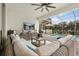Relaxing screened-in patio with comfortable seating, TV, and adjacent pool, perfect for outdoor entertainment at 8811 Bally Neal Loop, Davenport, FL 33896