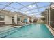 Screened-in pool area with lounge chairs, ceiling fan, and outdoor seating at 8811 Bally Neal Loop, Davenport, FL 33896
