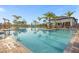 Large community swimming pool with lounge chairs and cabanas for shade and relaxation at 8811 Bally Neal Loop, Davenport, FL 33896