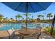 Enjoy outdoor living at this community pool with lounge seating, palm trees, and manicured landscaping at 8811 Bally Neal Loop, Davenport, FL 33896
