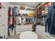 Organized walk-in closet with shelving, drawers, clothes racks, and a central ottoman at 8811 Bally Neal Loop, Davenport, FL 33896