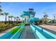Dual water slides offer refreshing fun in this community water park with manicured landscaping and palm trees at 8811 Bally Neal Loop, Davenport, FL 33896