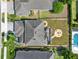Aerial view of backyard featuring a fire pit, pool, and screened in patio at 987 Nathan Ridge Rd, Clermont, FL 34715