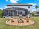 Backyard with screened patio, seating, and a fire pit at 987 Nathan Ridge Rd, Clermont, FL 34715