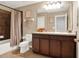 Well-lit bathroom with modern fixtures, dark wood cabinets and a shower-tub combo at 987 Nathan Ridge Rd, Clermont, FL 34715