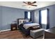 Bedroom with an accent wall, wood floors, and a cozy bed at 987 Nathan Ridge Rd, Clermont, FL 34715
