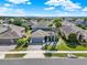 Two-story home with three palm trees, a gray roof and a two car garage at 987 Nathan Ridge Rd, Clermont, FL 34715