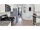 Bright kitchen featuring stainless appliances, granite counters, and a view into the dining area for easy entertaining at 987 Nathan Ridge Rd, Clermont, FL 34715