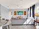 Bright living room with a large gray sectional, gray walls, wood-look tile flooring, and coastal accents at 987 Nathan Ridge Rd, Clermont, FL 34715
