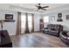 Spacious living room with tray ceilings, wood-look floors, and baseball decor at 987 Nathan Ridge Rd, Clermont, FL 34715